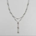 Zilverkleurige dubbele kralenketting met lariat-hanger