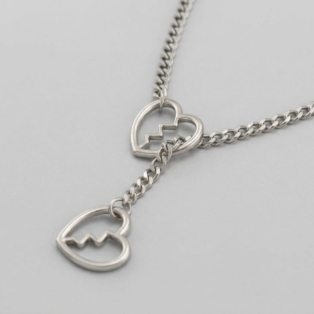 Ketting met curb-schakels, gebroken hartenring en lariat-hanger